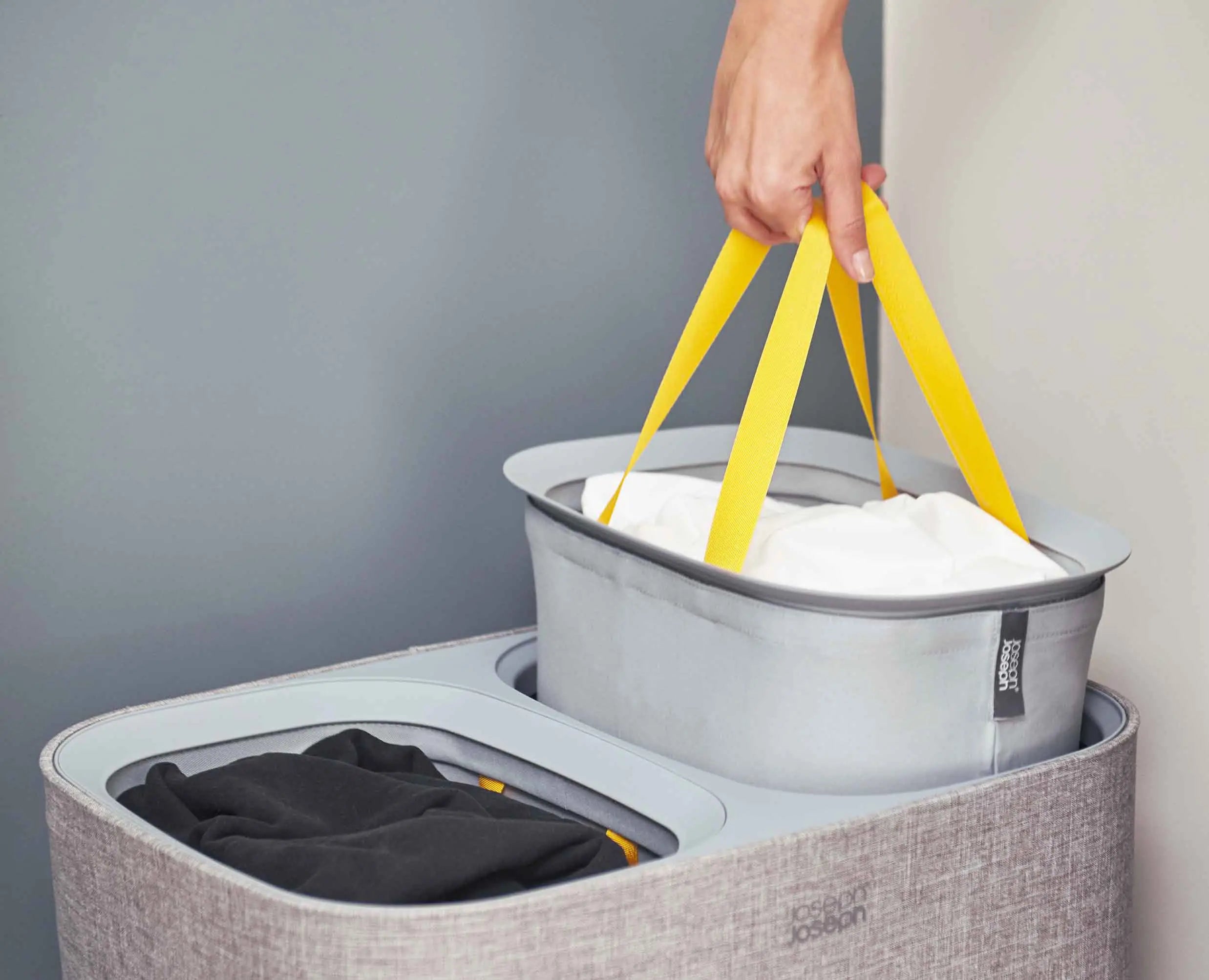 Grey Joseph Joseph Tota 90L laundry basket with two removable tote bags
